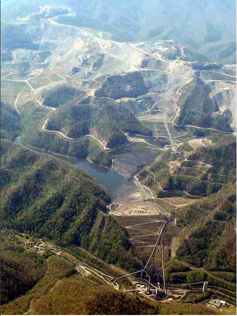 Blasted mountains (top); mandmade lake (impoundment) holding 2.8 billion gallons of toxic sludge (center), containment wall and conveyor belts leading down to Massey’s Goals Coal processing plant (bottom center), Massey coal silo and Marsh Fork Elementary School (bottom right), April 29, 2009/Vivian Stockman, flickr.com Blasted mountains (top); mandmade lake (impoundment) holding 2.8 billion gallons of toxic sludge (center), containment wall and conveyor belts leading down to Massey’s Goals Coal processing plant (bottom center), Massey coal silo and Marsh Fork Elementary School (bottom right), April 29, 2009/Vivian Stockman, flickr.com