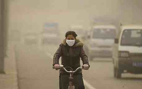 Cyclist rides in polluted air in Lanzhou, Gansu Province, China, Dec 5 06/ AP/EyePress, The Telegraph, telegraph.co.uk