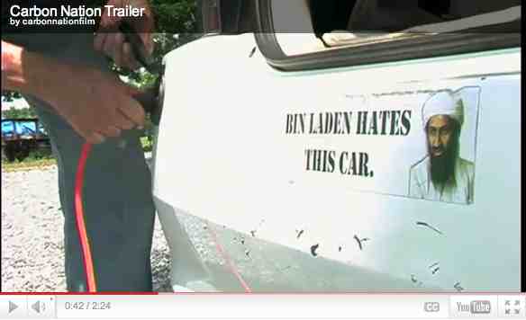 Former CIA director and hybrid car proponent R. James Woolsey plugs in his hybrid car, image from trailer for “Carbon Nation”/ carbonnationthemovie.com