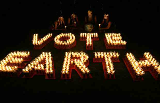 Men in traditional dress light candles, Jakarta, Indonesia, Earth Hour, March 28, 2009/Dadang Tri, Reuters, The Vancouver Sun, vancouversun.com