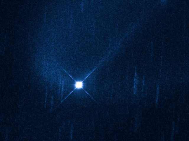 Hubble Image of Aftermath of Suspected Collision of Asteroid (596) Scheila with unidentified smaller object, December 