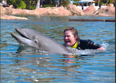 Unidentified dolphin & visitor, Discovery Cove, Orlando, FL, undated/Laurie K., Discovery Cove, discoverycove.com