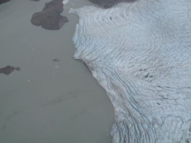 Section of the Greenland ice sheet meets a fjord fed by melt-water, August 1, 2013/John Ferro, Poughkeepsie NY Journal , USA Today