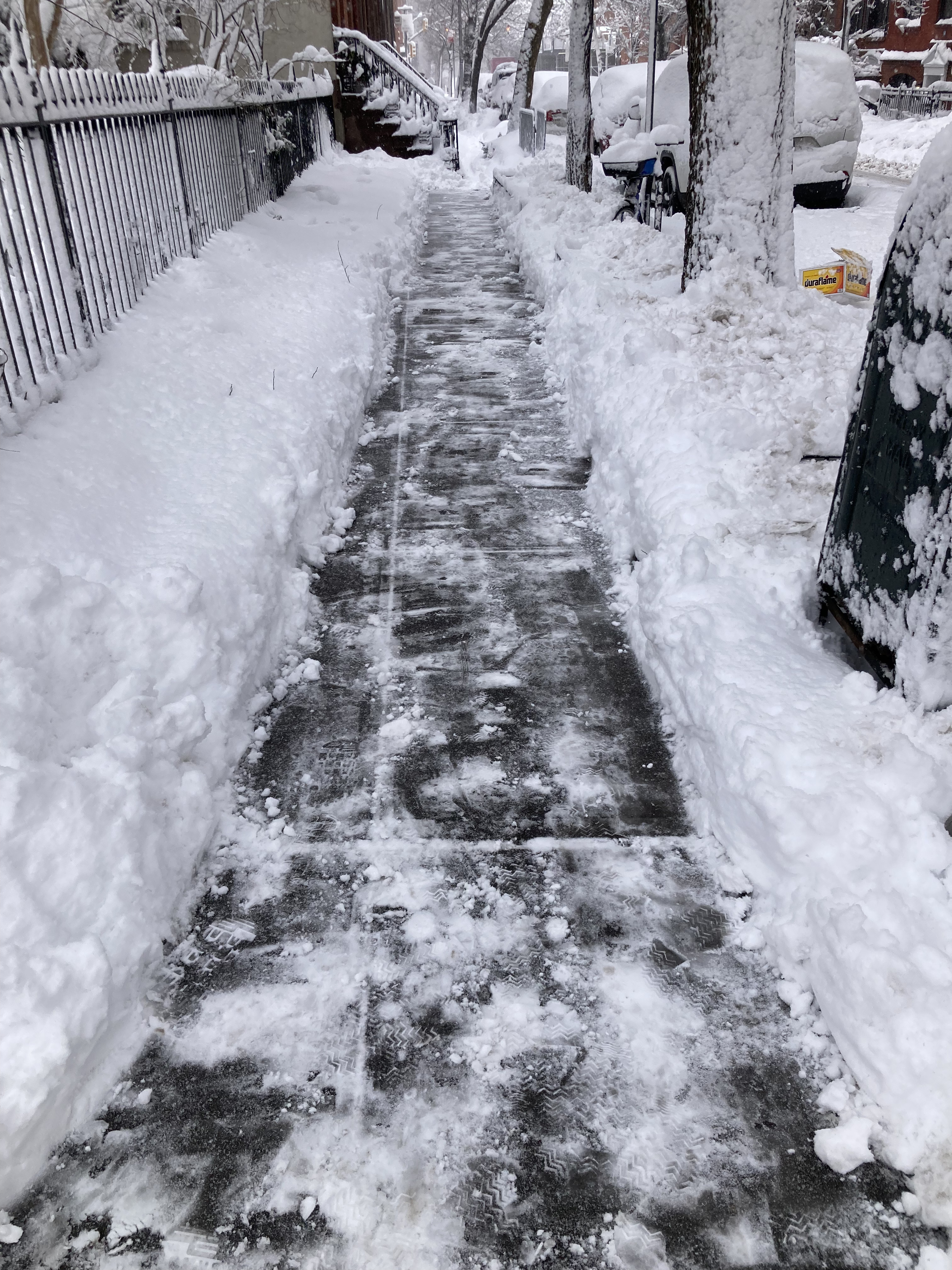 Sidewalk on Jane Street side of Jane Street Garden, Greenwich Village NYC, 1:02 p.m. Monday, February 23, 2026 / Marc Wallace
